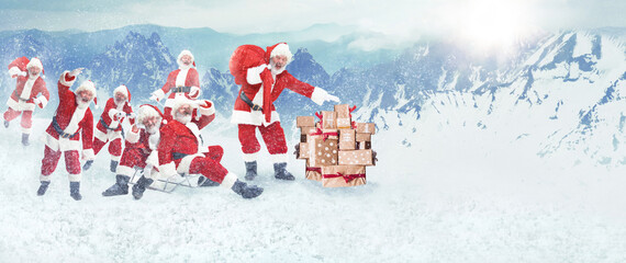 Group of cheerful senior men, Santa Clauses on costumes carrying gifts, presents. Snow forest and...