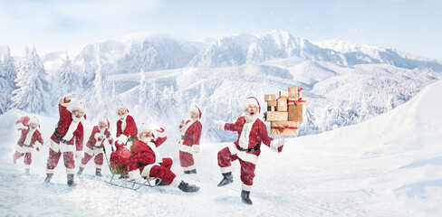 Ho-ho-ho. Santa Clause in costumes carrying present boxes, gifts over snowy forest and mountain...