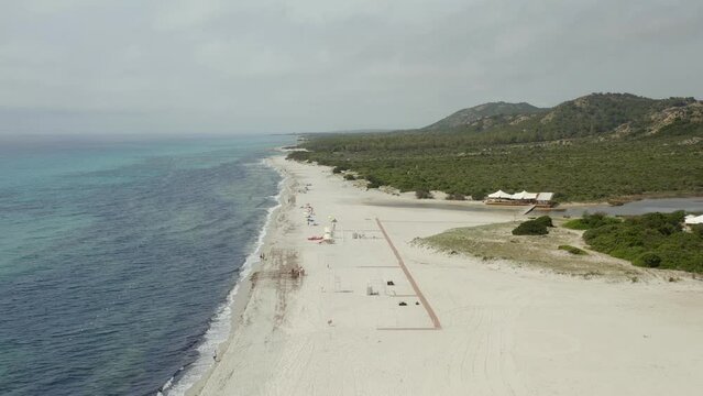 Aerial drone view of Spiaggia di Berchida beach with white sand and turquoise water in Sardinia, Italy