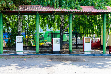 Fototapeta na wymiar Old red fuel pumps at the gas station
