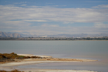 Horizon and mountains in the distance. View of the lagoon in Spain. Blue sky and clouds.