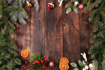 Christmas and New Year 2024 background with fir branches covered with snowflakes on a wooden table,...