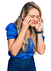 Young blonde woman wearing casual clothes with hand on head, headache because stress. suffering migraine.