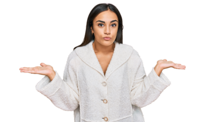 Young brunette woman wearing casual clothes clueless and confused expression with arms and hands raised. doubt concept.