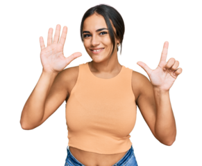 Young brunette woman wearing casual clothes showing and pointing up with fingers number seven while smiling confident and happy.