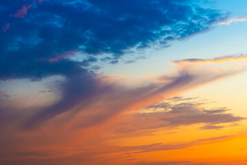 Naklejka na ściany i meble Sunset sky with sunset clouds, sun rays and dramatic sky