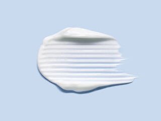 Cream cosmetic anti aging  texture stroke isolated on pale blue background. Hyaluronic acid skincare moisturizer product