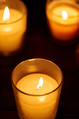 Aromatic Candles in Glass: Warm Glow on Dark Background, Close-up