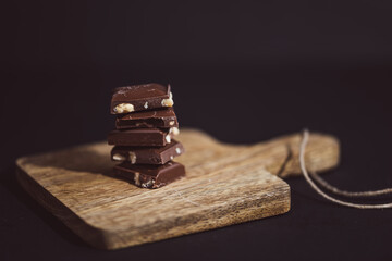 pieces of chocolate stacked on a wooden board