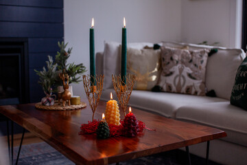 A selection of burning beeswax Christmas candles. Large pillars and pinecone candles make lovely...