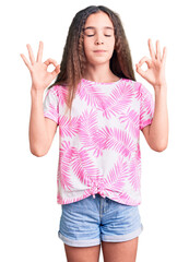Cute hispanic child girl wearing casual clothes relax and smiling with eyes closed doing meditation...