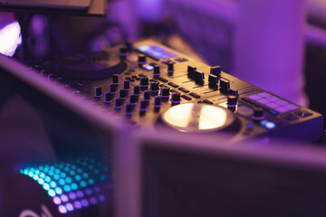 deejay controller at party - nightlife people lifestyle concept. dj mix table with blue tones in...