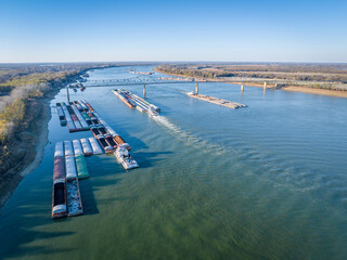 towboats and barges on the Ohio River above a confluence with the Mississippi at Cairo, Illinois,...
