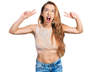Young caucasian woman doing victory sign and peace gesture angry and mad screaming frustrated and furious, shouting with anger looking up.