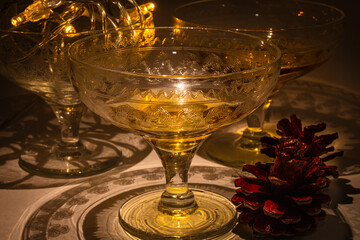Vintage champange glasses for holiday celebration with festive lights