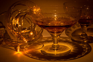 Vintage champange glasses for holiday celebration with festive lights