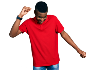 Young african american man wearing casual red t shirt dancing happy and cheerful, smiling moving casual and confident listening to music