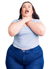 Young plus size woman wearing casual clothes shouting and suffocate because painful strangle....