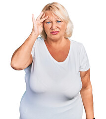 Middle age blonde woman wearing casual white t shirt worried and stressed about a problem with hand on forehead, nervous and anxious for crisis