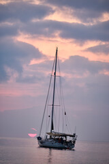 A sailboat rests during sunrise on the coast of Peñiscola.