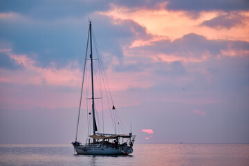 Fototapeta premium A sailboat rests during sunrise on the coast of Peñiscola.