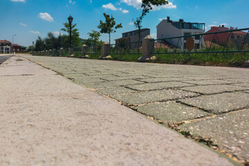 Pavement with the texture of a brick wall knocked out during the laying of hot asphalt going into the distance, with perspective and close-up