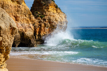 View of idyllic nature landscape with rocky cliff shore and waves crashing on. Camillo beach in Lagos. West Atlantic coast of Algarve region, south of Portugal.