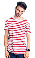 Young hispanic man wearing casual clothes skeptic and nervous, frowning upset because of problem....