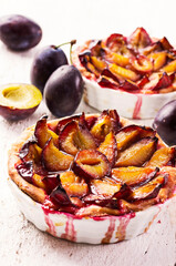 Traditional German plum cake with sliced plums served as close-up in a backing form