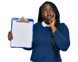 Young black woman with braids holding clipboard with blank space serious face thinking about question with hand on chin, thoughtful about confusing idea