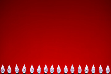 White LED faceted Christmas Lights bottom border against a red background