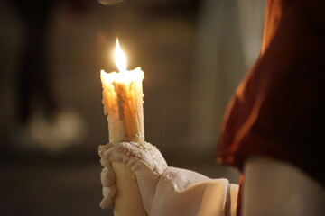Beautiful image of a Nazarene and his candle in procession