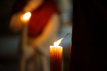 Closeup of a Nazarene and his candle in procession