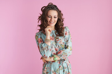smiling trendy female in floral dress on pink