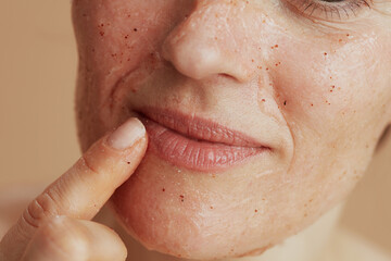 Closeup on young woman with face scrub