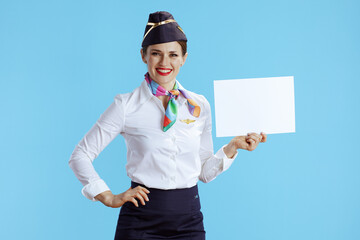 flight attendant woman on blue showing blank a4 paper sheet