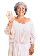 Senior woman with gray hair wearing bohemian style showing and pointing up with fingers number five while smiling confident and happy.