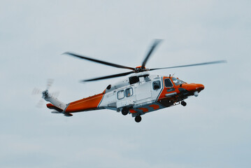 Fototapeta na wymiar Search And Rescue At Sea. Coast Guard Helicopter On Scene. Assistance For People And Vessels In Distress. Coordination Of Medical Evacuations At Sea. Safety Of Life At Sea.