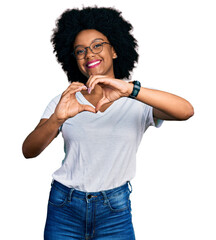 Young african american woman wearing casual white t shirt smiling in love doing heart symbol shape with hands. romantic concept.