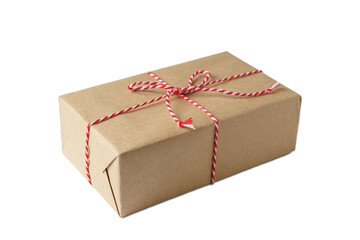 Christmas and New Year gift box wrapped in brown craft kraft paper with red and white baker's twine, ribbon bow isolated on white, transparent background, PNG