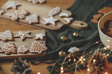 Christmas holiday traditions, atmospheric family time. Gingerbread cookies with icing on rustic...