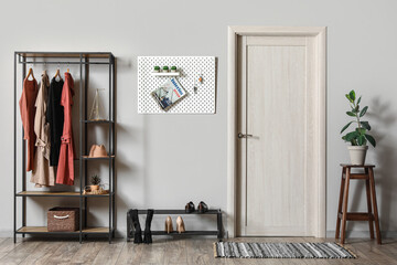 Interior of hall with pegboard, clothes rack and shoe stand