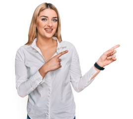 Young caucasian woman wearing casual clothes smiling and looking at the camera pointing with two hands and fingers to the side.