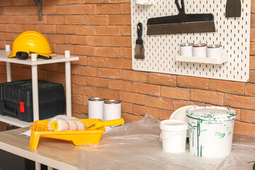 Pegboard with trowels and paint cans in workshop