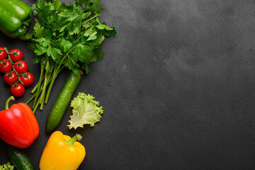 Different fresh vegetables and parsley on black background