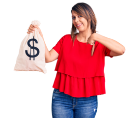 Young beautiful woman holding money bag with dollar symbol pointing finger to one self smiling happy and proud