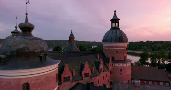 Aerial Beautiful View Of Gripsholm Castle Under Cloudy Sky, Drone Flying Forward Towards Lake During Sunset - Mariefred, Sweden