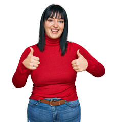 Young hispanic woman wearing casual clothes success sign doing positive gesture with hand, thumbs up smiling and happy. cheerful expression and winner gesture.