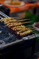 Klopo satay, Serundeng Seasoned satay Typical of Surabaya. being roasted, sate klopo khas surabaya
