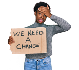 Young african american girl holding we need a change banner stressed and frustrated with hand on head, surprised and angry face